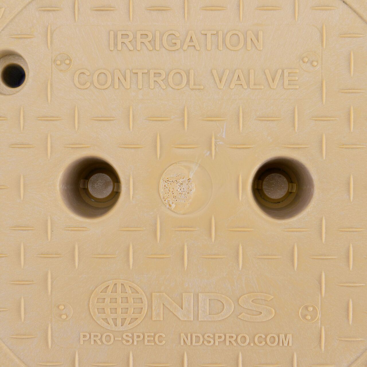 Closeup view of the Irrigation Control Valve markings on the Sand Irrigation Control Valve cover (NDS 312BCSAND) for the NDS 10 in. Round Pro-Spec® Series Valve Box