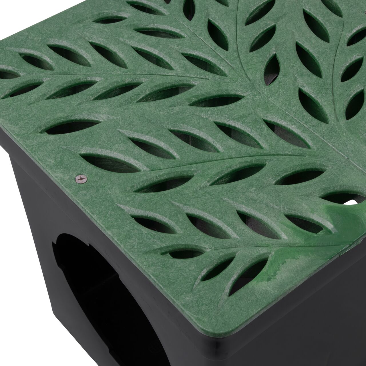 Closeup view of NDS 12 in. Square Catch Basin Drain Grate, Decorative Botanical Design, Green Plastic (NDS 1218GR) and how it fits securely within a 12 in. Square Catch Basin Drain with 2 Openings (NDS 1200*); retail