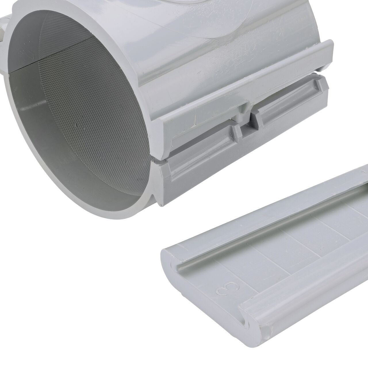 Closeup of the wedge latch uninstalled on the NDS Clamp-It™ Rigid PVC Saddle with 1 in. slip connection on top (NDS 454010) for 4 in. PVC pipe