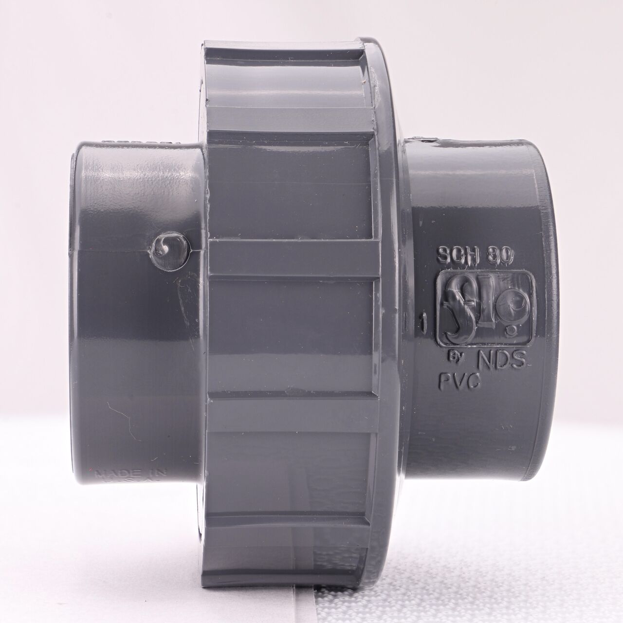 Side view of PVC Union, 1-1/2 in. Sch. 80 S X FPT showing two threaded ends that slide onto Sch. 80 pipe ends (NDS U-1000-ST)