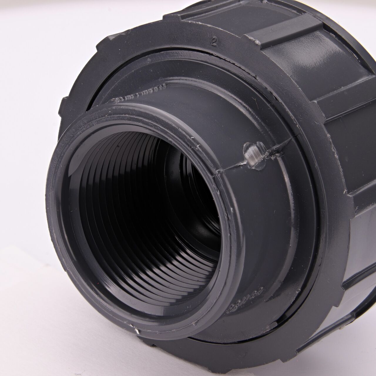 Closeup view of one threaded end on the NDS 1-1/4 in. PVC Union (NDS U-1250-T) which provides a corrosion-free connection between pipes and prevents costly property damage