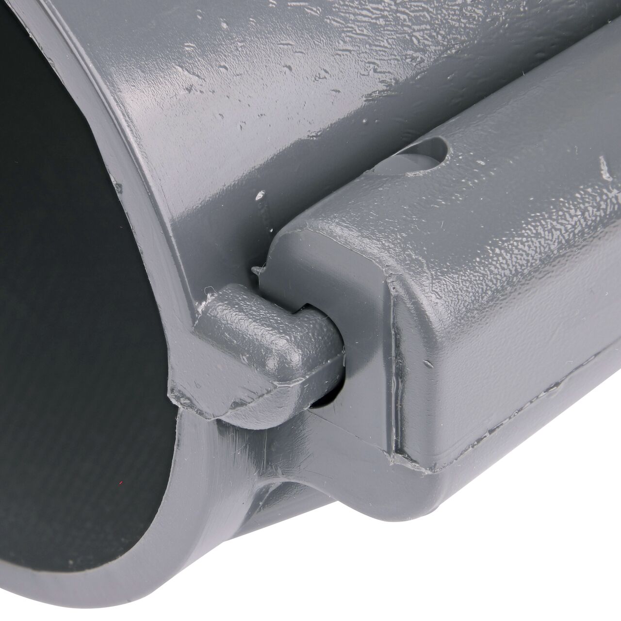 Closeup of the hinge closed on the NDS Clamp-It™ Rigid PVC Saddle with 1-1/2 in. slip connection on top (NDS 453015) for 3 in. PVC pipe