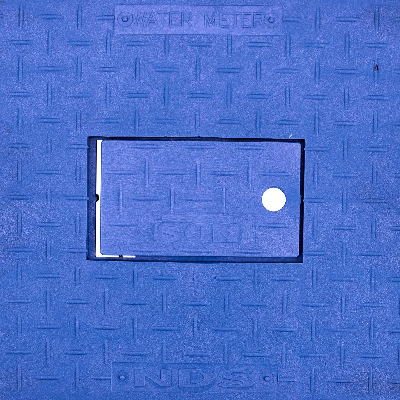 Closeup view of the Water Meter markings and Plastic reader door on the Blue Water Meter Drop-in cover for the NDS 13 in. X 20 in. Rectangular Standard Series Meter Cover (NDS D1500-DIRBLU)