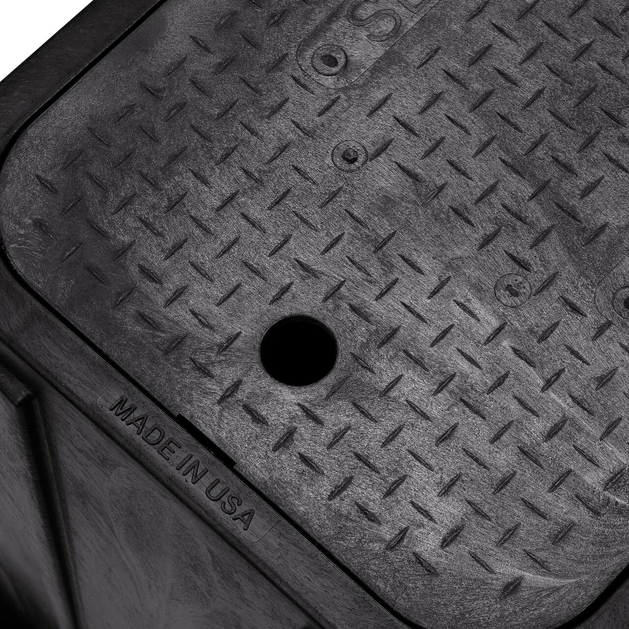 Closeup view of the pipe hole on the Black NDS 14 in. X 19 in. Rectangular Standard Series Meter Box (NDS D1200-DISBSWR) for water and irrigation pipe connections