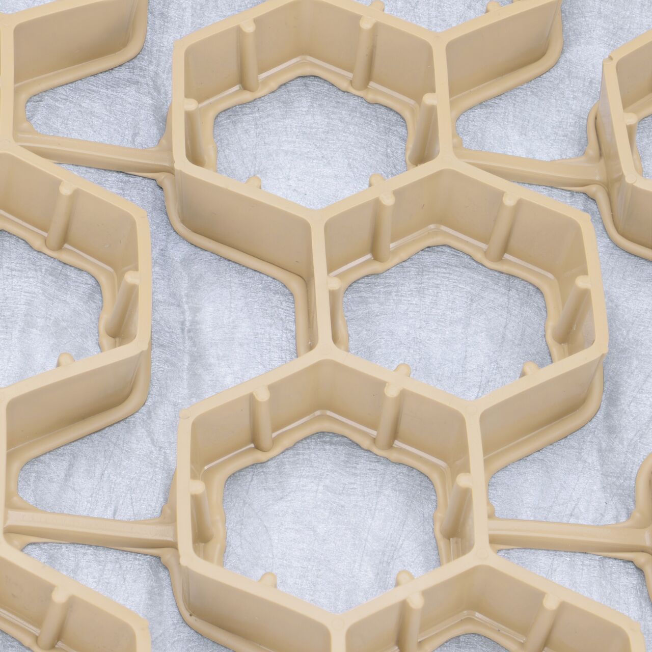 Each 2 ft. X 2 ft. section of the tan NDS EZ Roll® Gravel Paver (NDS GP4X150T) features 72 nested honeycomb cells