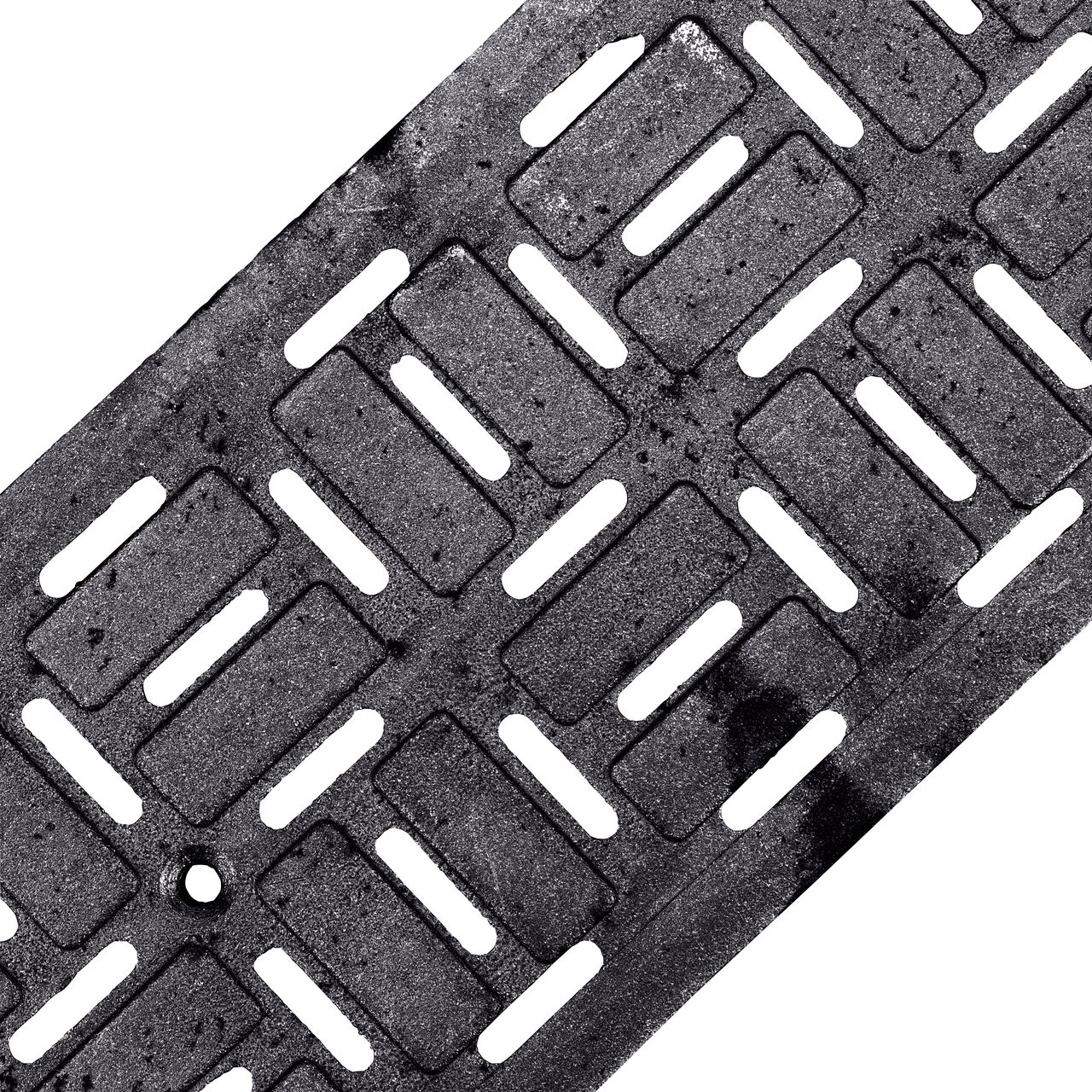 Angled View of the ductile iron Dura Slope™ Channel Drain Grate (NDS DS-604) decorative brick pattern design