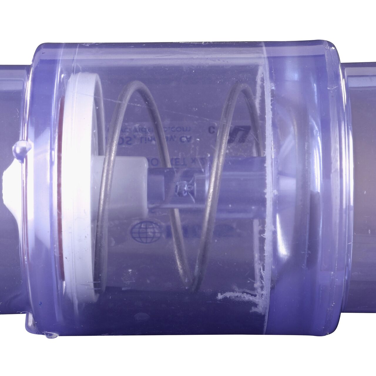 Closeup of the 5 lb. spring which controls the flapper to prevent water from flowing the wrong direction in the NDS Clear 1-1/2 in. slip end by 2 in. spigot end PVC Air Check Valve with 5 lb. Spring (NDS 1055C20)