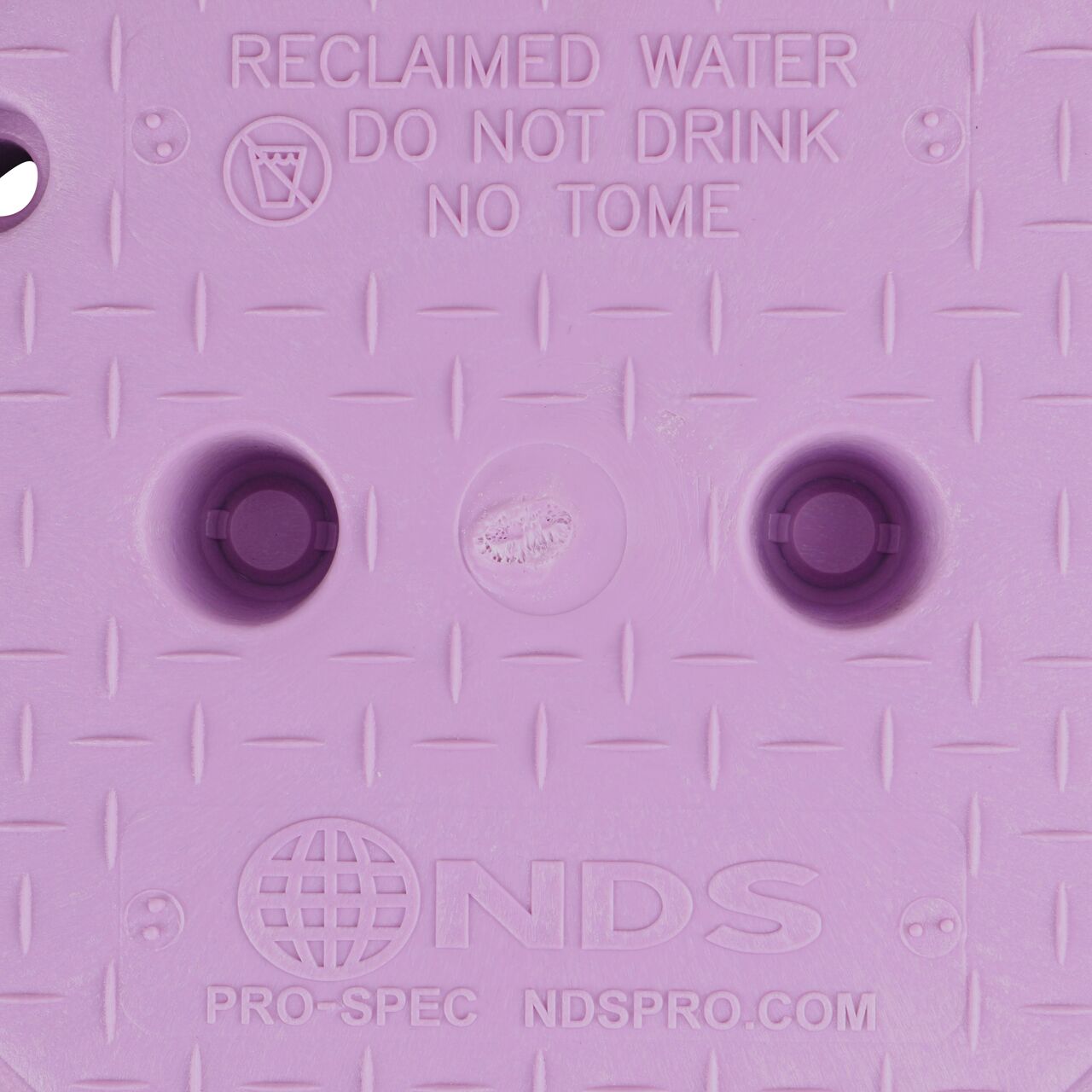 Closeup view of the Reclaimed Water markings on the Purple Reclaimed Water cover for the NDS 10 in. Round Pro-Spec® Series Valve Box (NDS 311CR)