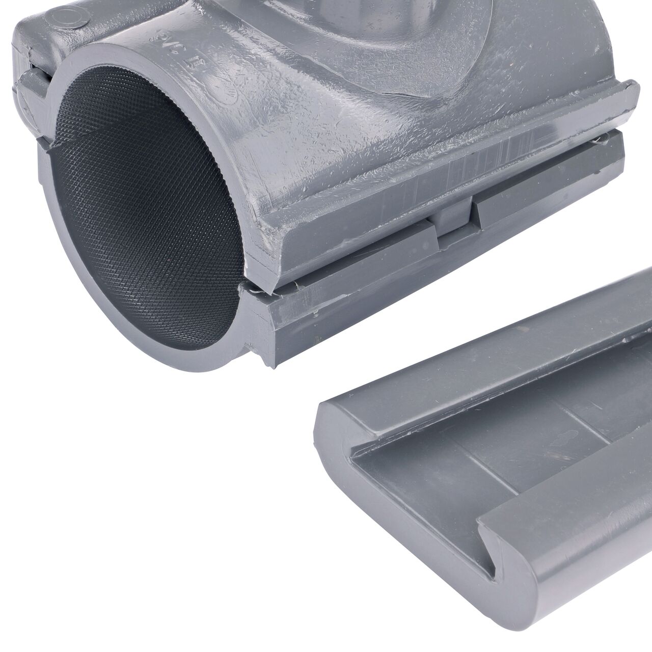 Closeup of the wedge latch uninstalled on the NDS Clamp-It™ Rigid PVC Saddle with 1 in. FPT connection on top (NDS 422010) for 2 in. PVC pipe