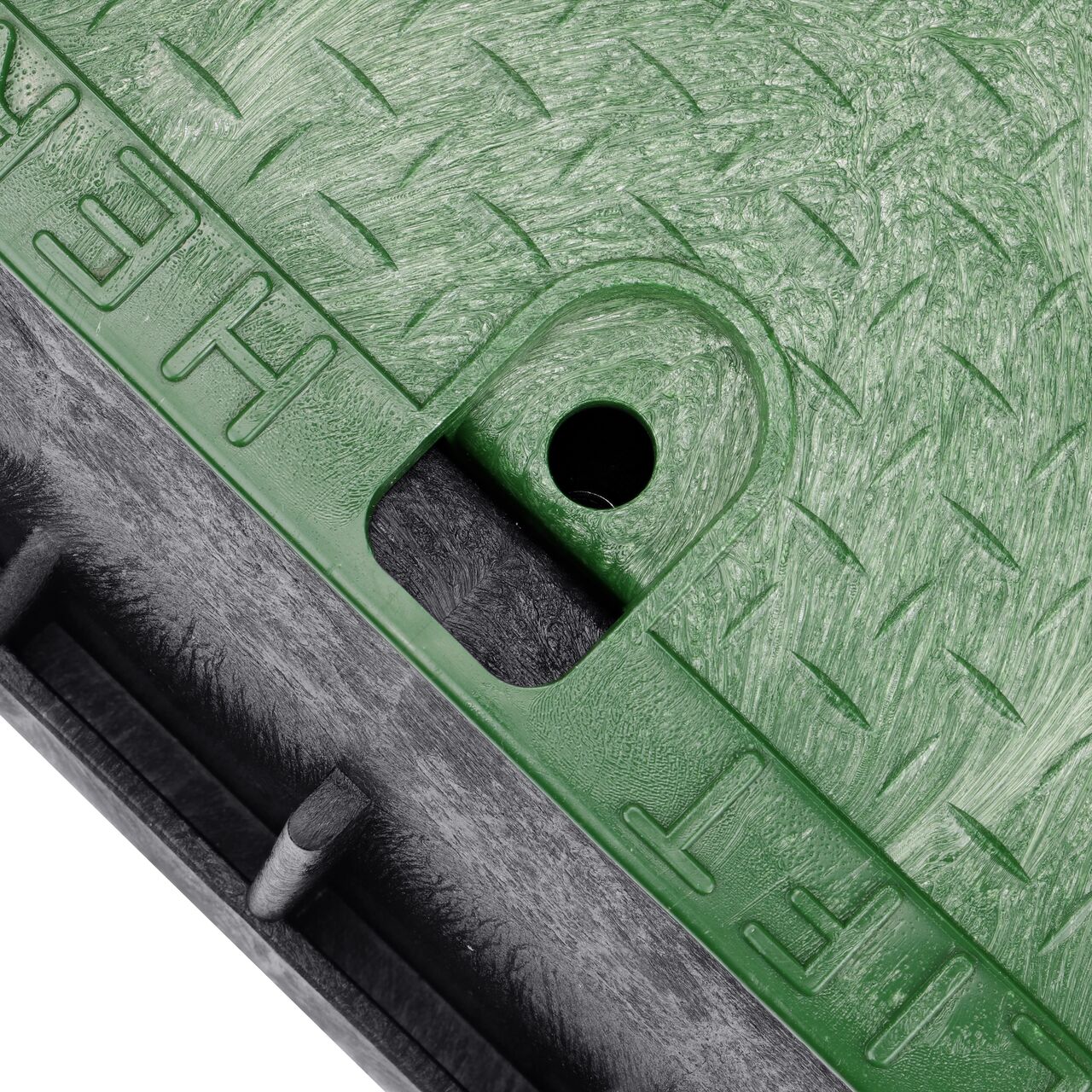 The valve box lid securely in place on the NDS 13 in. X 20 in. Rectangular Standard Series Tapered Extension Black Box and Green Irrigation Control Valve Cover (NDS 119TBC) keeping components protected against the elements, foot traffic, lawn care equipment, and potential vandalism while keeping them out of sight