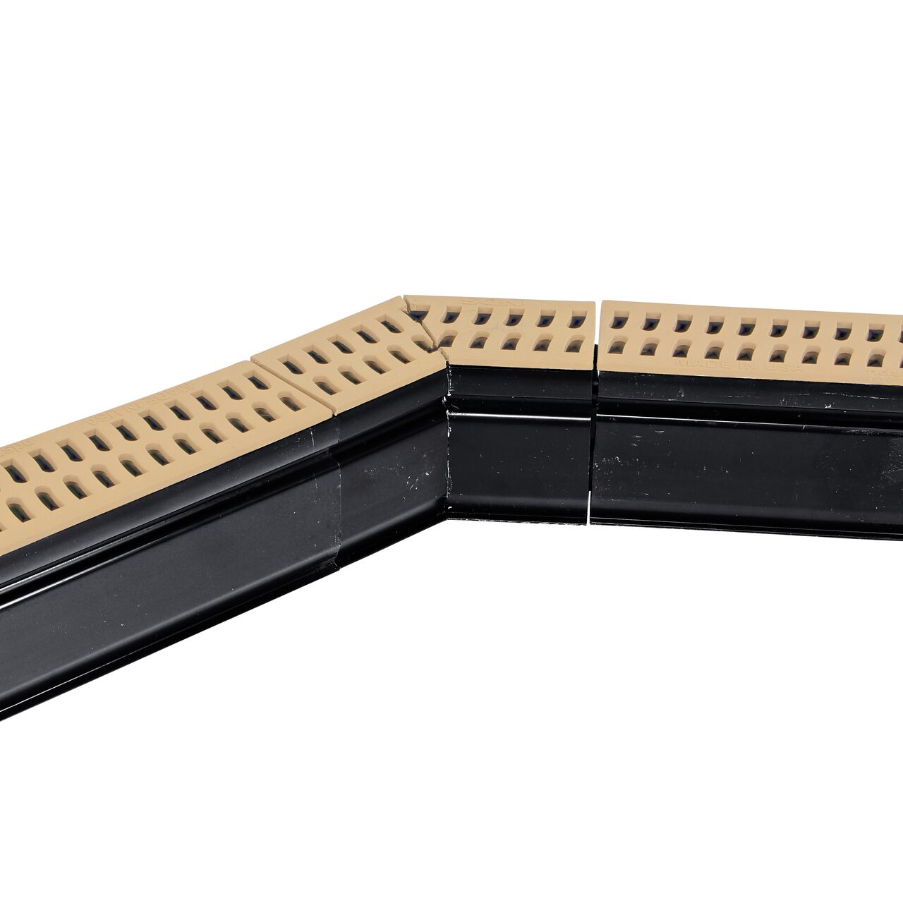 Installation shot with two channel drains and grates to the NDS Sand Slim Channel™ Drain 45° Elbow and Grate (NDS 9302)