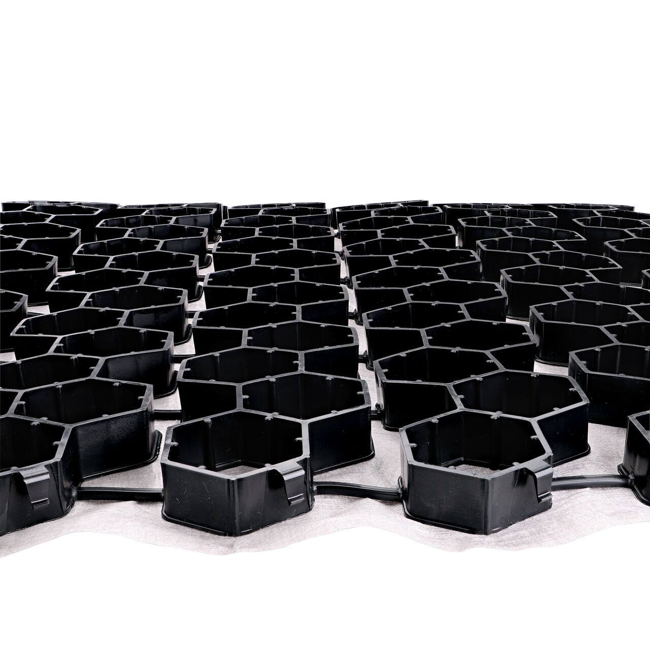 Secure two Black NDS EZ Roll® Gravel Paver rolls together side by side with the Top-down locking tabs for a quicker, easier installation; no tools required