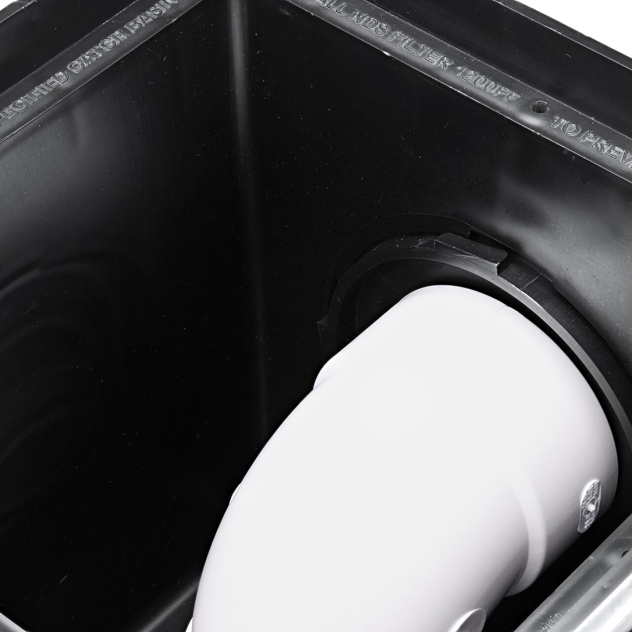 The inside view of the NDS Outlet Adapter with Internal Spigot for adjustable invert height (NDS 1242) installed on a 12 in. Catch Basin Drain (NDS 1200) with a S&D Fitting attached turned downward
