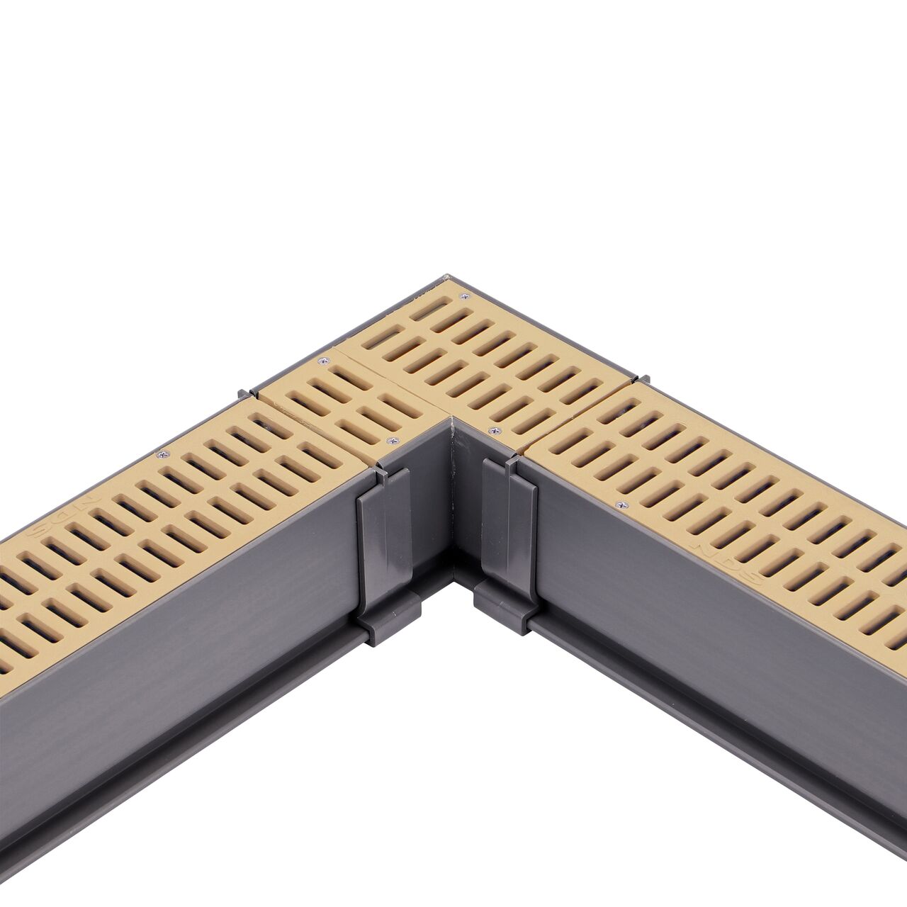 Fully installed NDS Sand Mini Channel™ Drain 90° Elbow and Grate (NDS 5383) with couplers and channel drains with grates