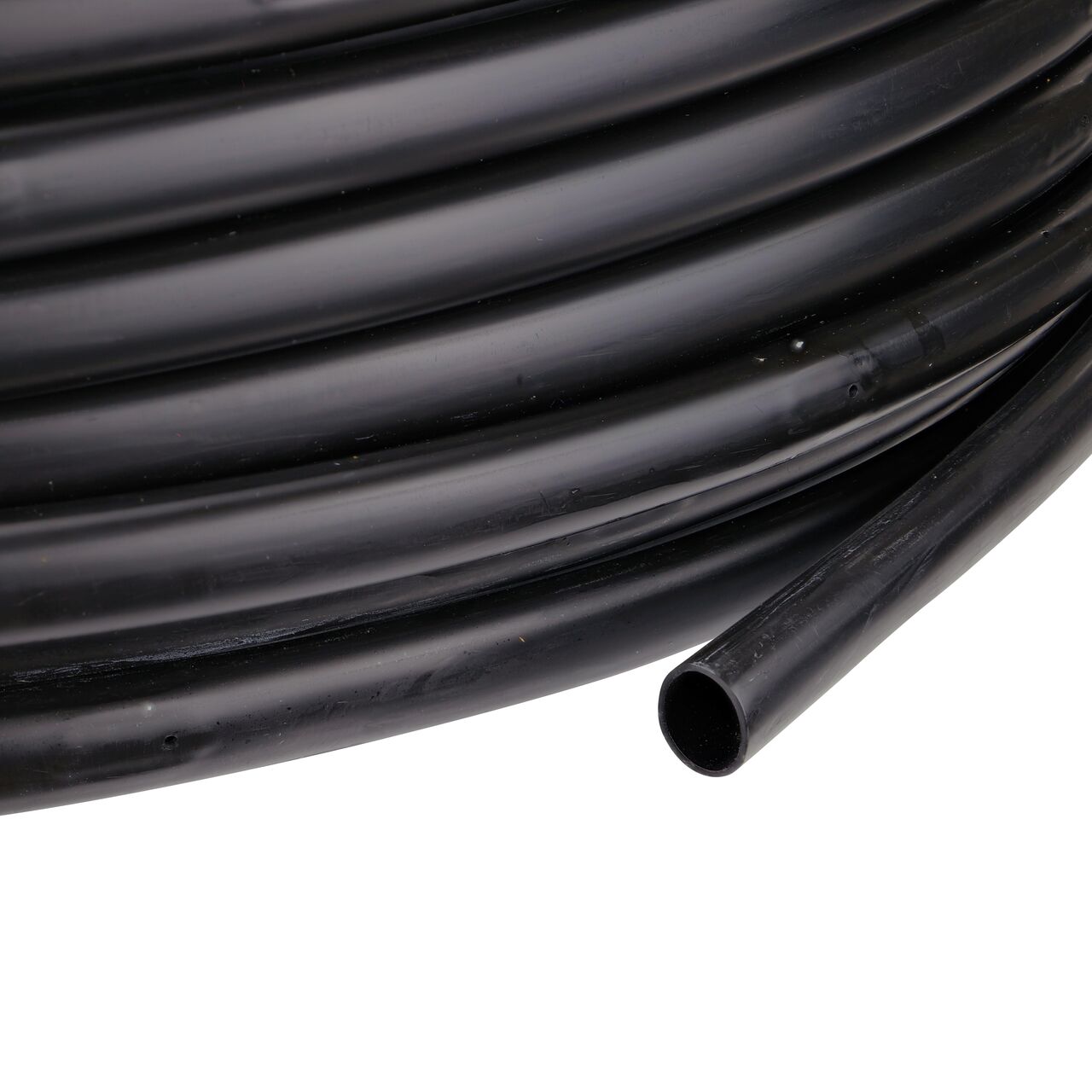 Closeup of the end of the NDS 500 ft. Black Tubing with 0.5 GPH Pressure Compensating Emitters iwth 12 in. Spacing  to show how to pull out the dripline (NDS SFPC-BL-7212-05, NDS SFPC-BL-7412-05, NDS SFPC-BL-7418-05)